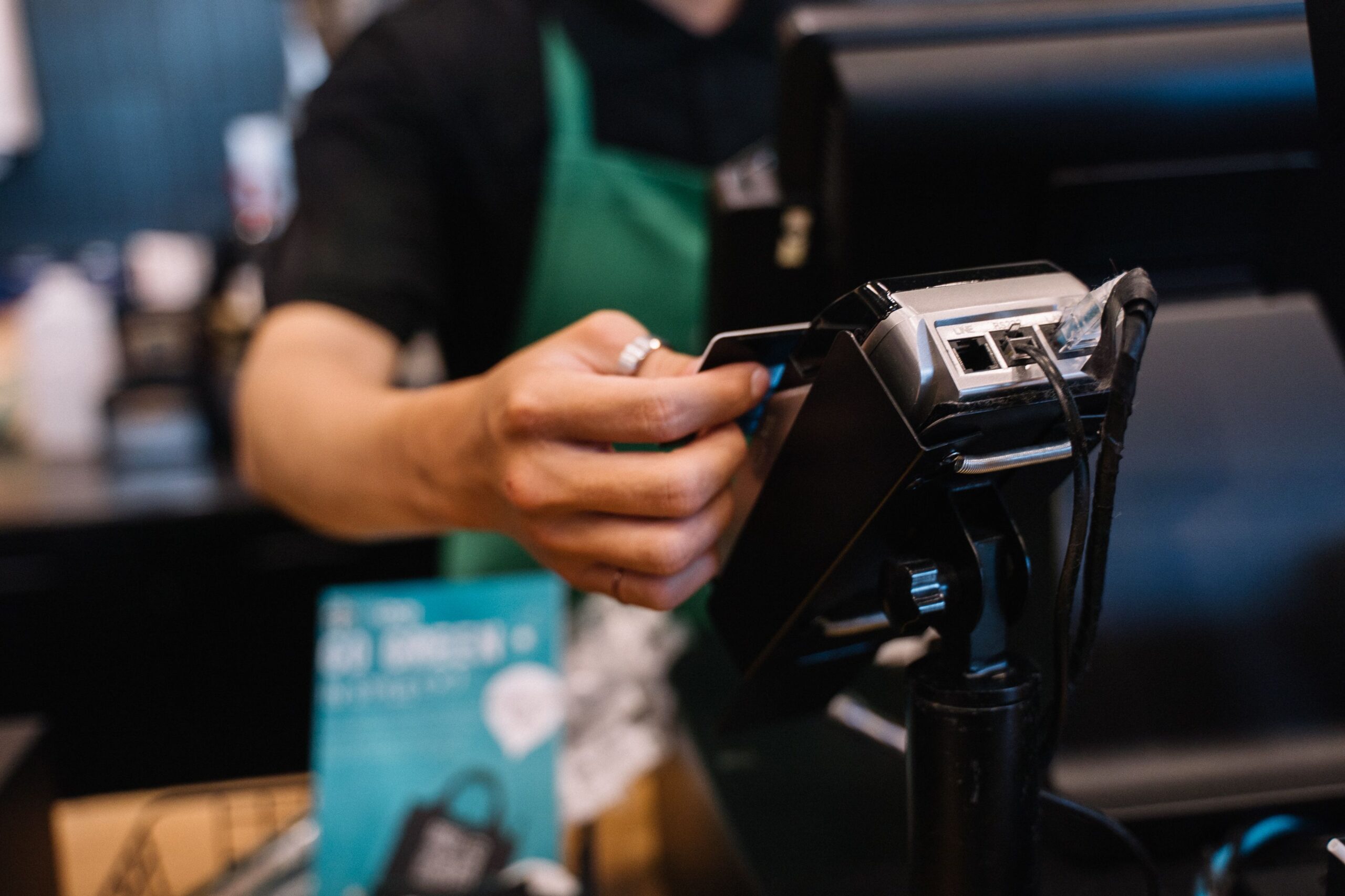 Customer paying by credit card at a payment terminal