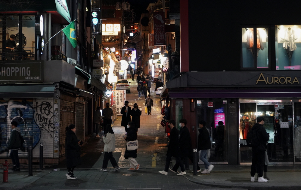 People walking through Itaewon nightlife streets in Seoul