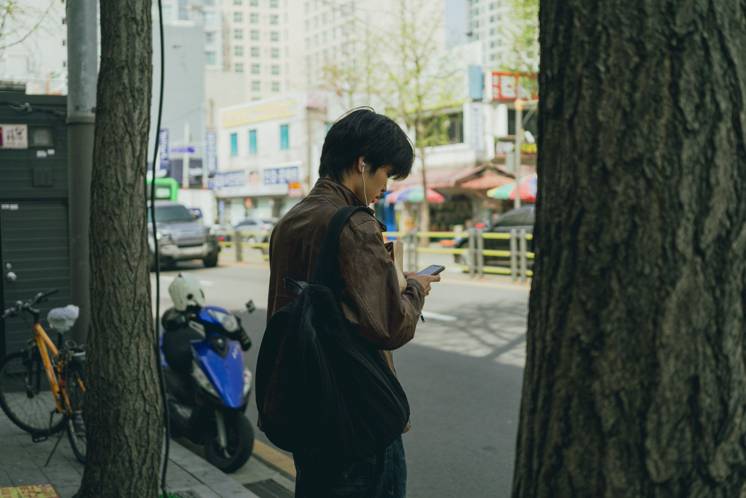 Traveler using a smartphone on a street in Seoul, South Korea